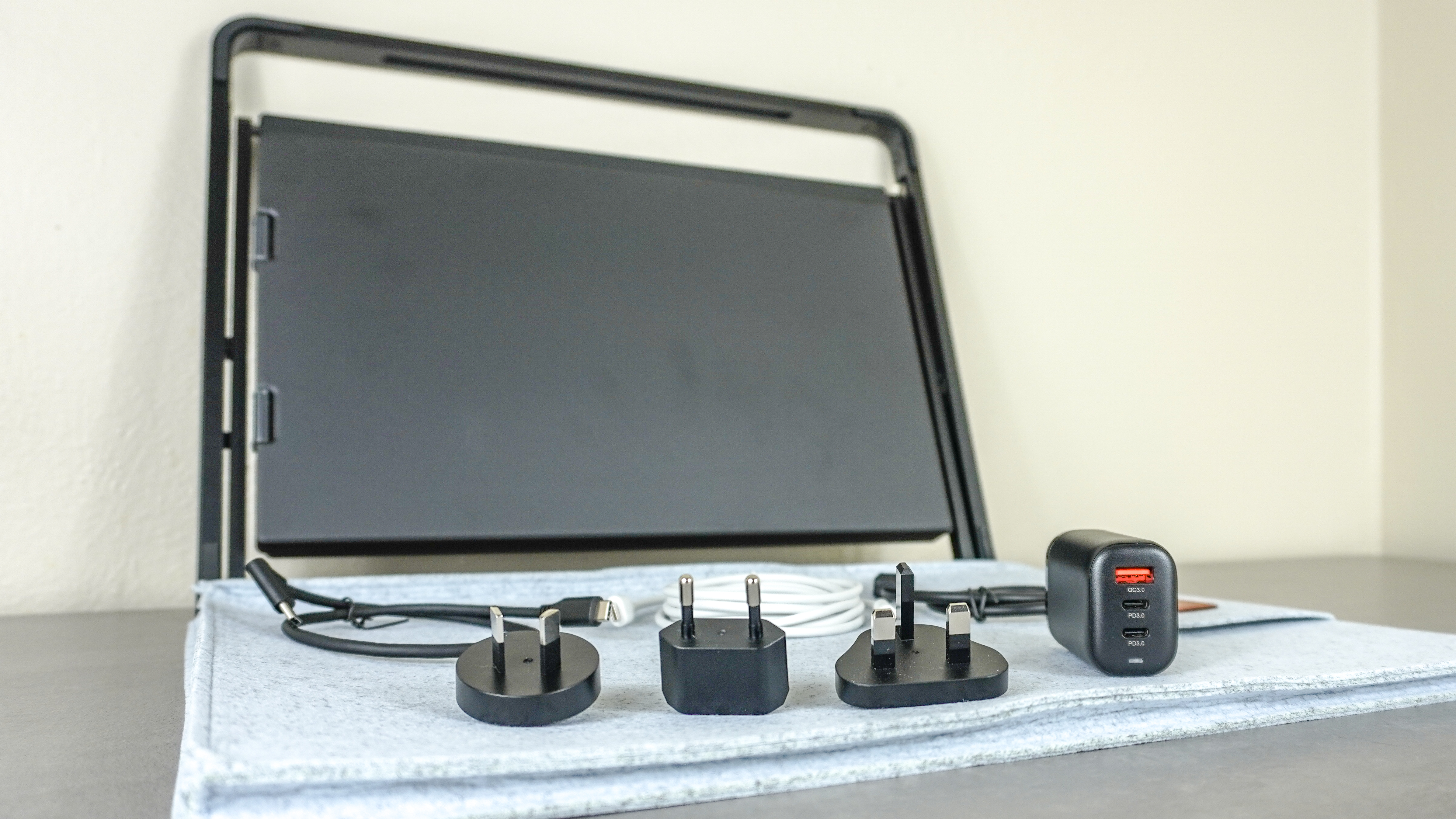 The Aura Triple Aero 15.6 Pro Max unboxed on a table with all of its included accessories laid out in front of it