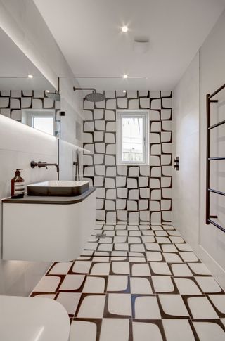 small wet room with black and white tiles