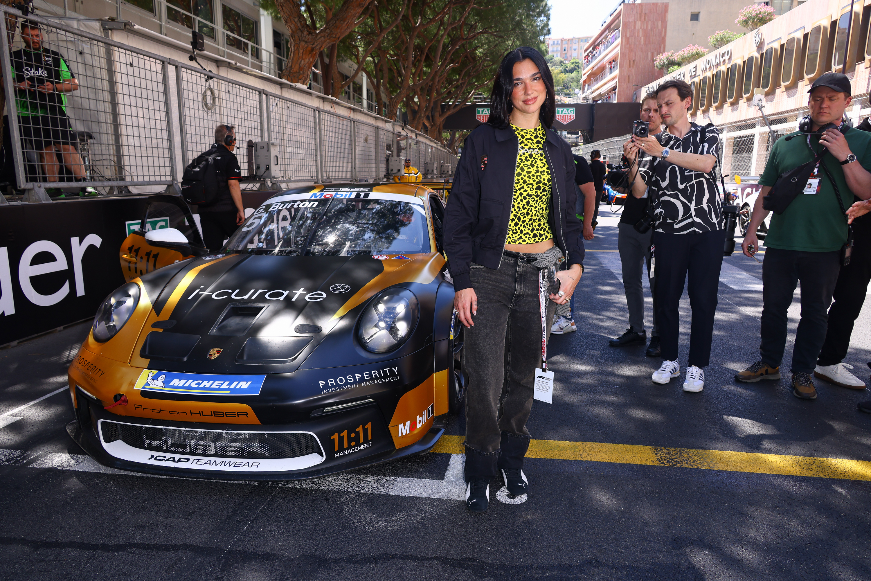 Dua Lipa attends the F1 Grand Prix in Monaco wearing Puma Speedcat OG Sneakers, Coperni boyfriend jeans and a leopard print top