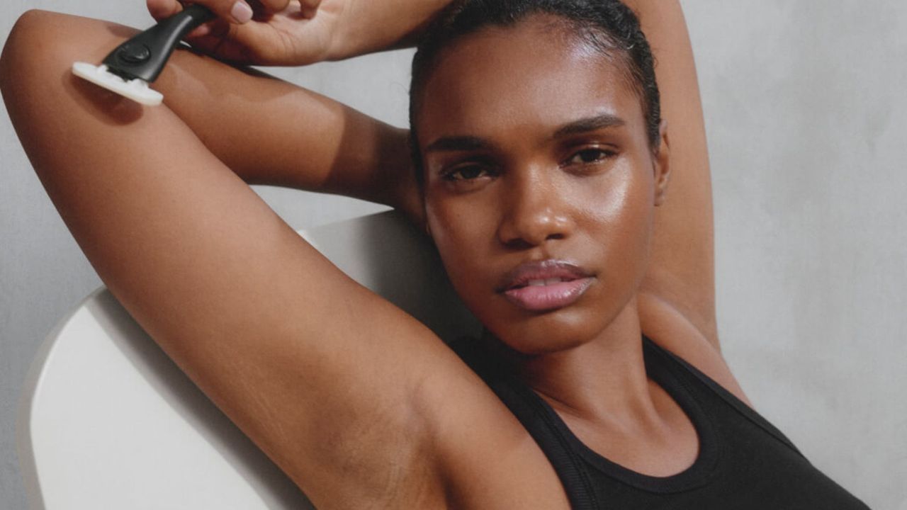 woman holding one of the best razors from the article