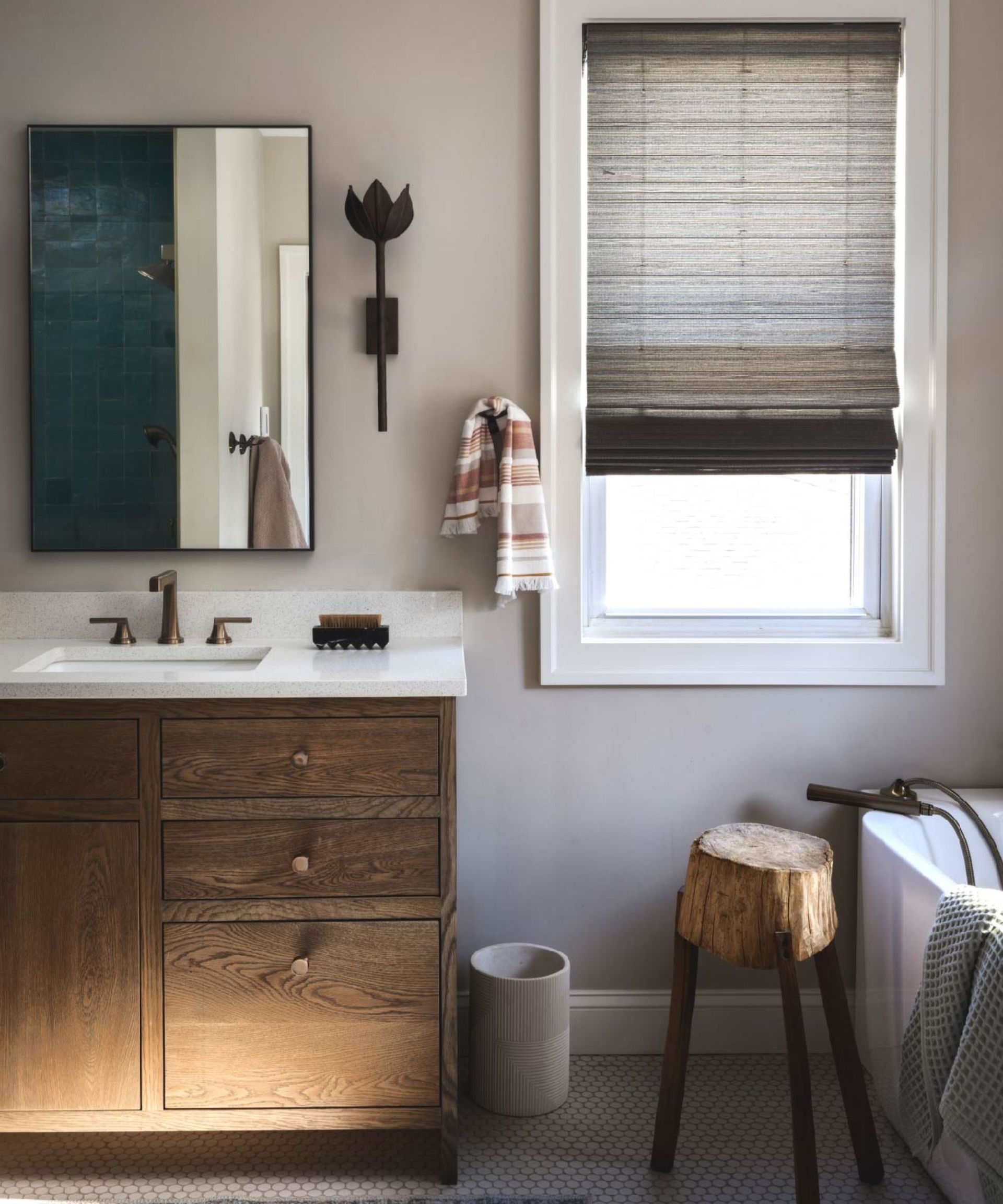 Beige bathroom with wall sconces