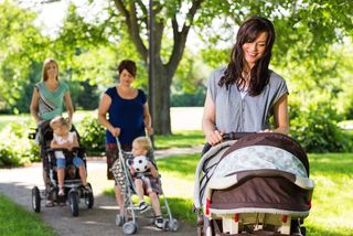 women with strollers in park