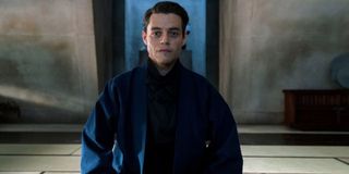 No Time To Die Rami Malek sitting in his lair