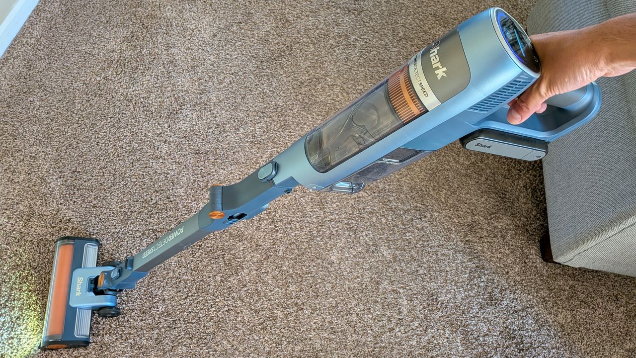 Person cleaning carpet with Shark PowerDetect Speed vacuum cleaner