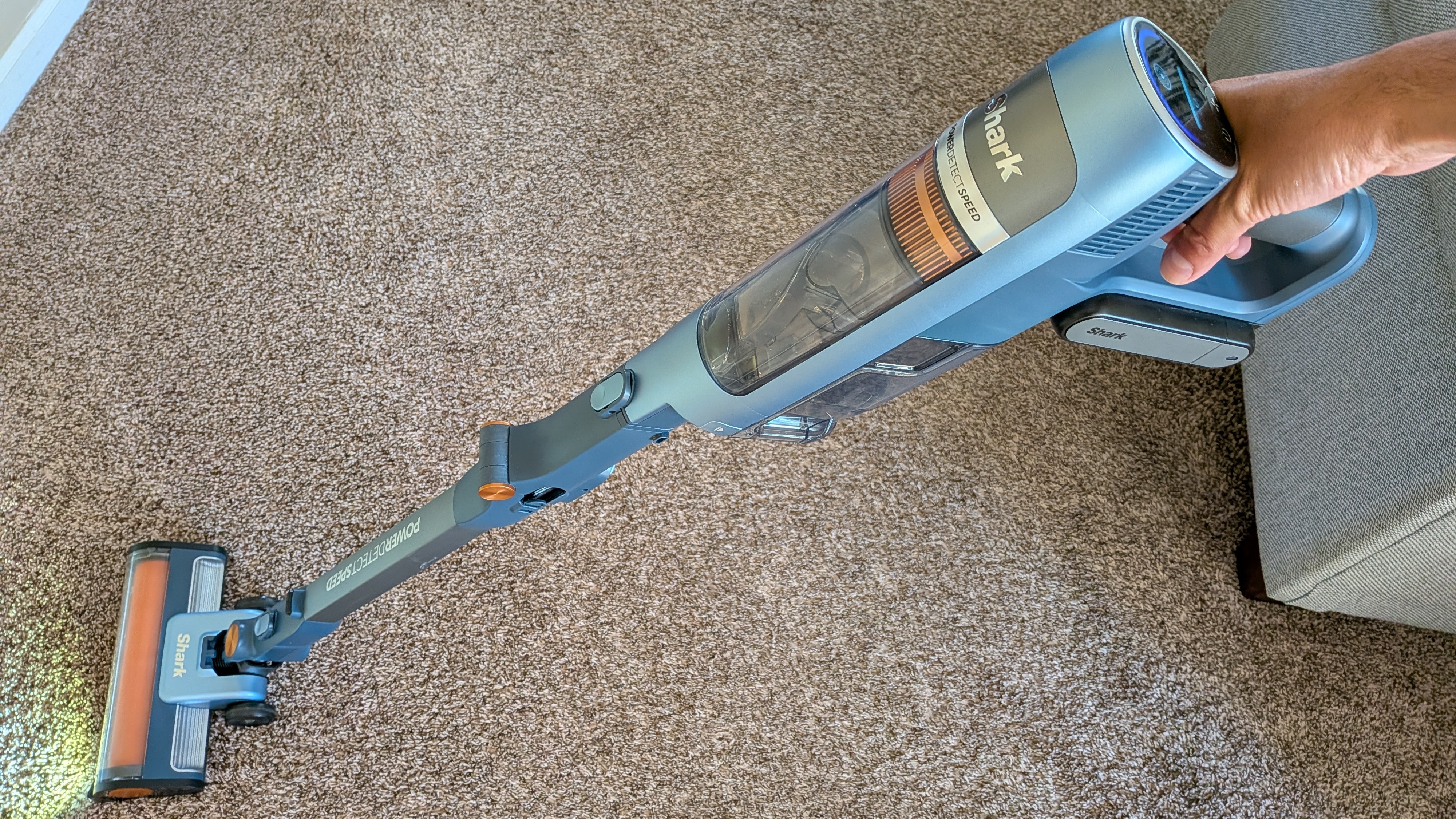 Person cleaning carpet with Shark PowerDetect Speed vacuum cleaner