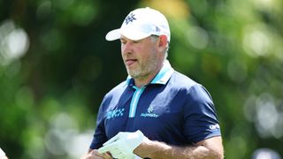 Lee Westwood of Majesticks GC reacts after playing his shot from the eighth tee during day one of the LIV Golf Invitational - Singapore at Sentosa Golf Club on May 03, 2024 in Singapore.