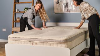 Two Tom's Guide testers feeling the top of the Birch Luxe Natural mattress