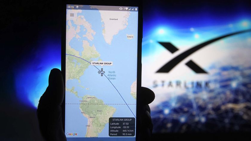 A satellite tracker image is seen displayed on a smartphone with a Starlink logo in the background