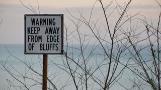 Warning sign at Scarborough Bluffs, overlooking Lake Ontario, Canada