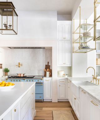 White Shaker kitchen with blue range and large kitchen island