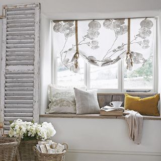 window seat with washed out curtains and soft furnishings