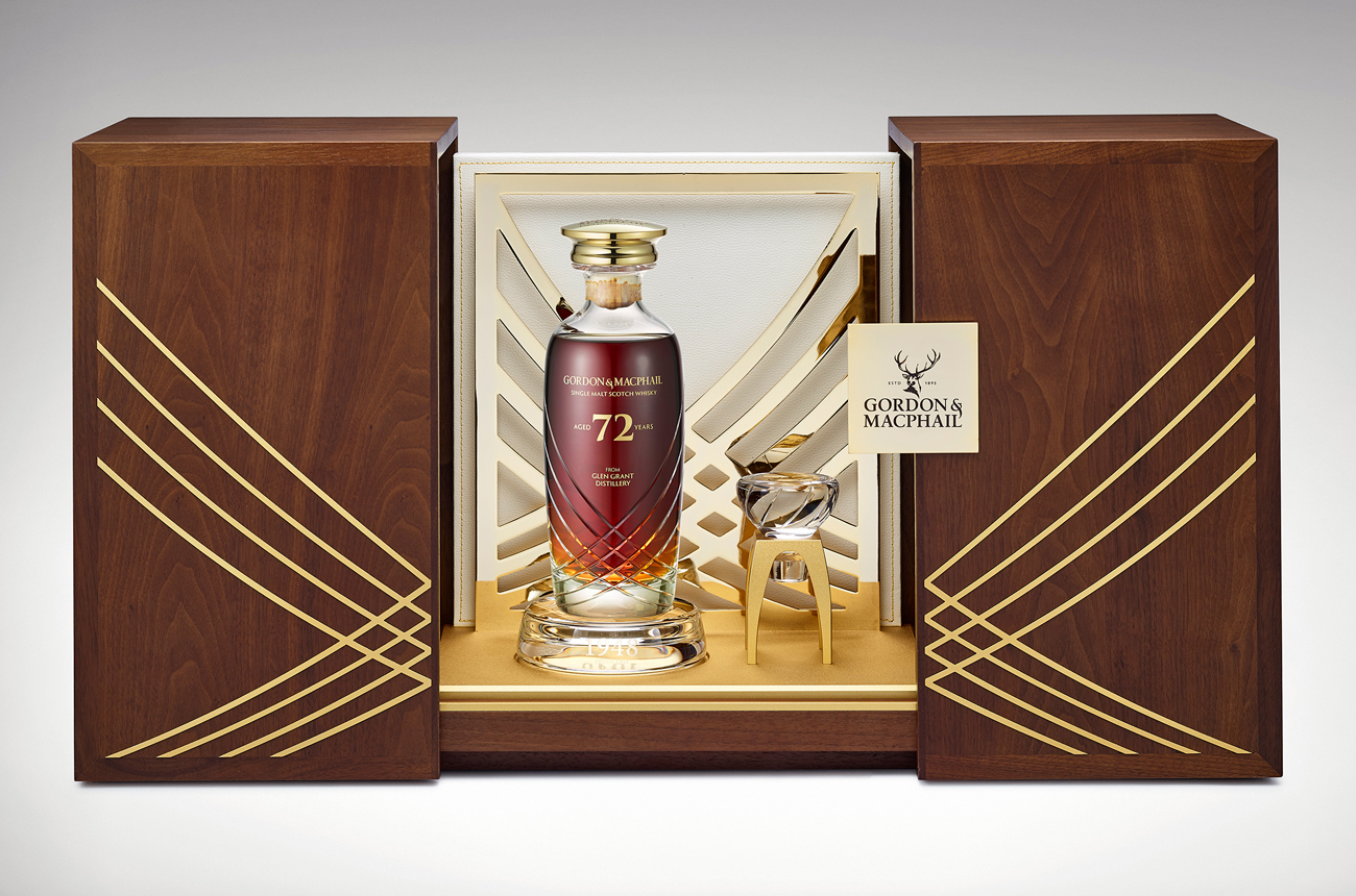 A bottle of whisky in a crystalo decanter and presentation case