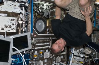 NASA astronaut Timothy "TJ" Creamer floats inside the European Columbus module aboard the International Space Station in May 2010.