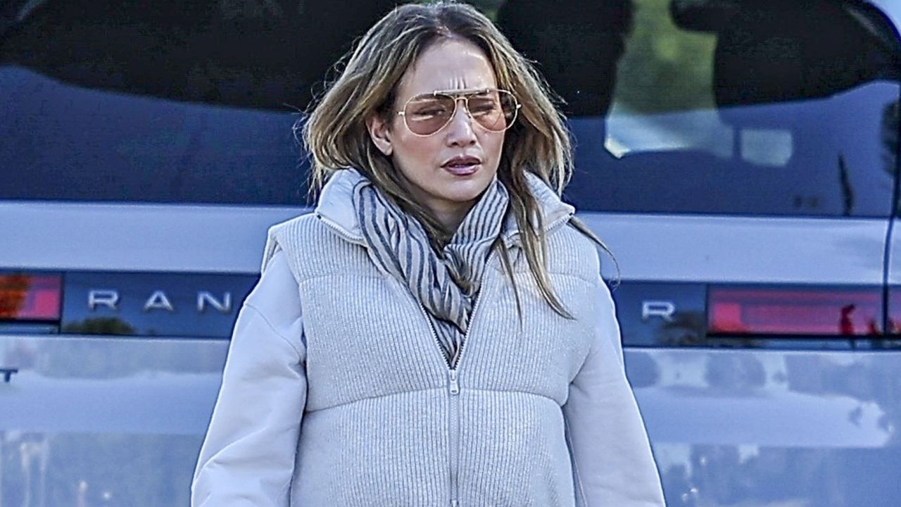 Jennifer Lopez wears a puffer vest over a sweatshirt with sweatpants and combat boots