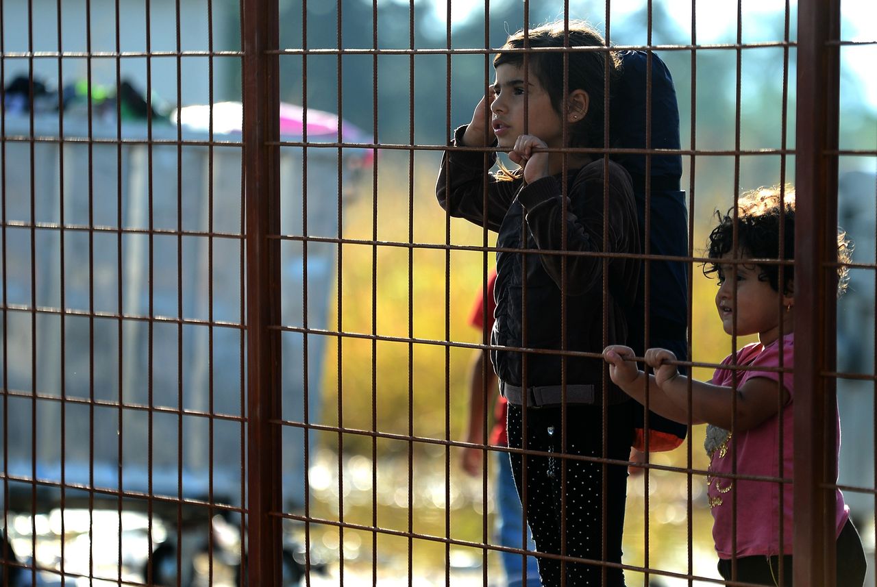 Migrant children wait in Macedonia. 