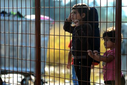 Migrant children wait in Macedonia. 