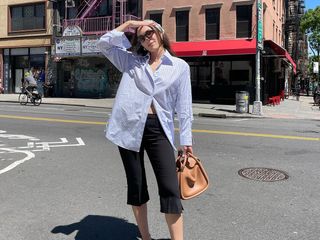 Anna LaPlaca in a button down shirt and capri pants.