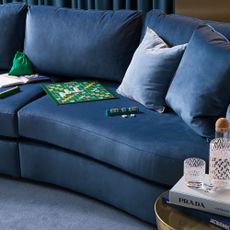 The new made-to-order Sacha curved sofa from Habitat in a blue colourway in a tonal living room