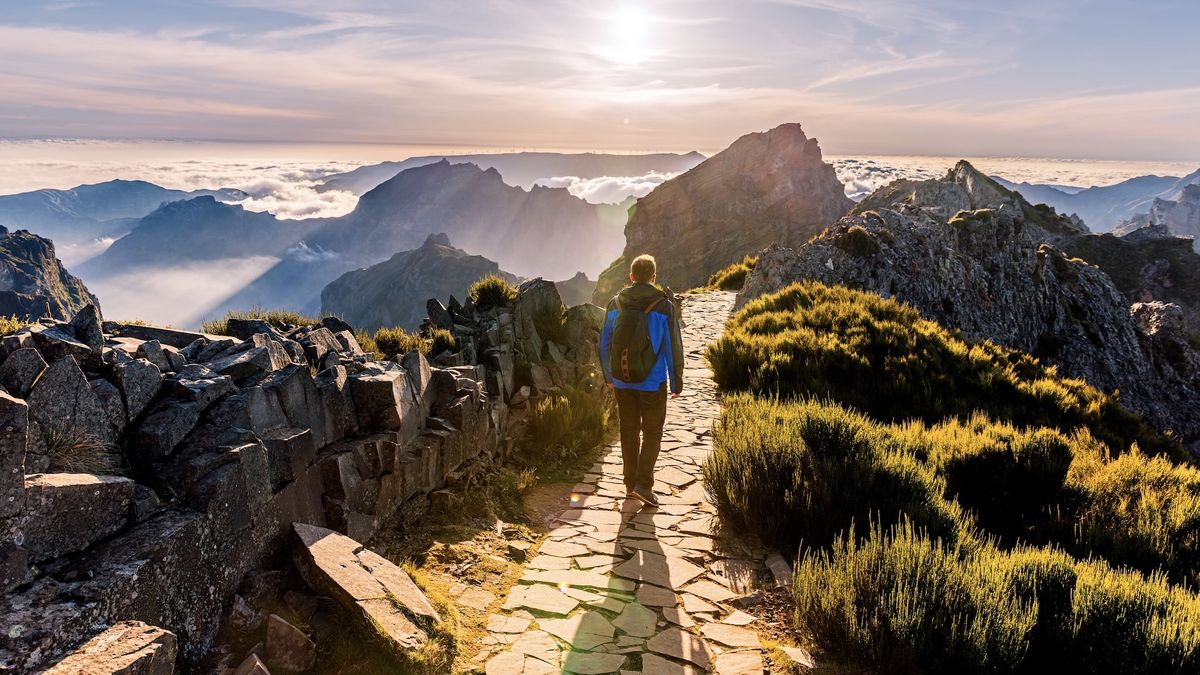 Man hiking at Pico do Arieiro at sunset, Madeira, Portugal 