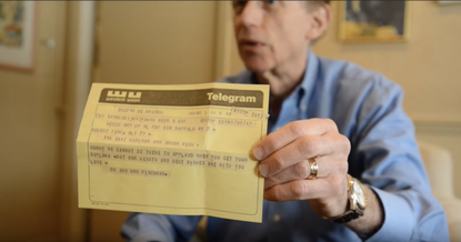Robert Fink holds his long-lost telegram.