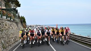 The pack rides in Alassio, Liguria, during the Milan-San Remo 2024 one-day classic cycling race, 