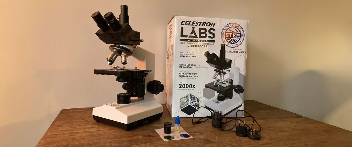 Celestron Labs CB2000C microscope on a wooden table