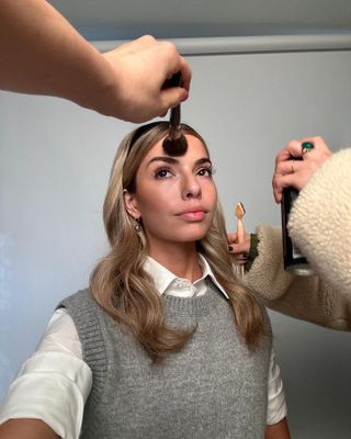 Content Creator Kit Keenan having her makeup done be L'Oreal Paris artists