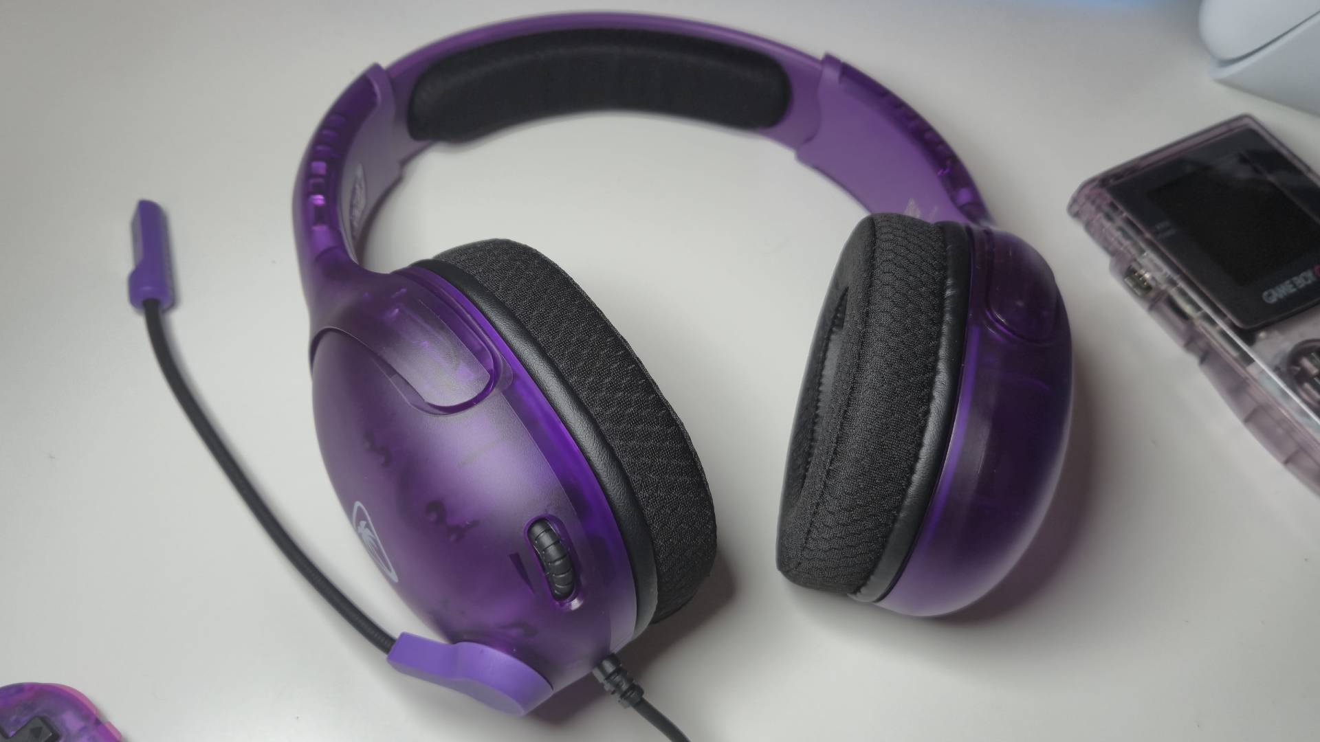 Photo by Rosalie Newcombe of the Ghost Purple Airlite Fit wired headset by Turtle Beach sitting on a white desk.