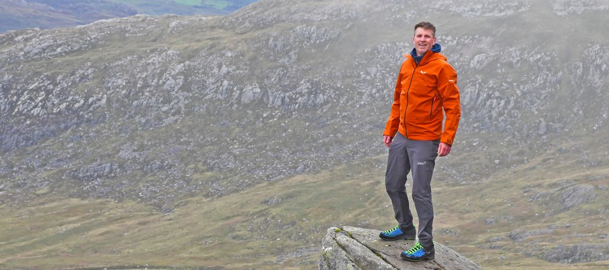 Man wearing Salewa Puez Gore-Tex Paclite Jacket while standing on Cannon Rock on Tryfan, Snowdonia