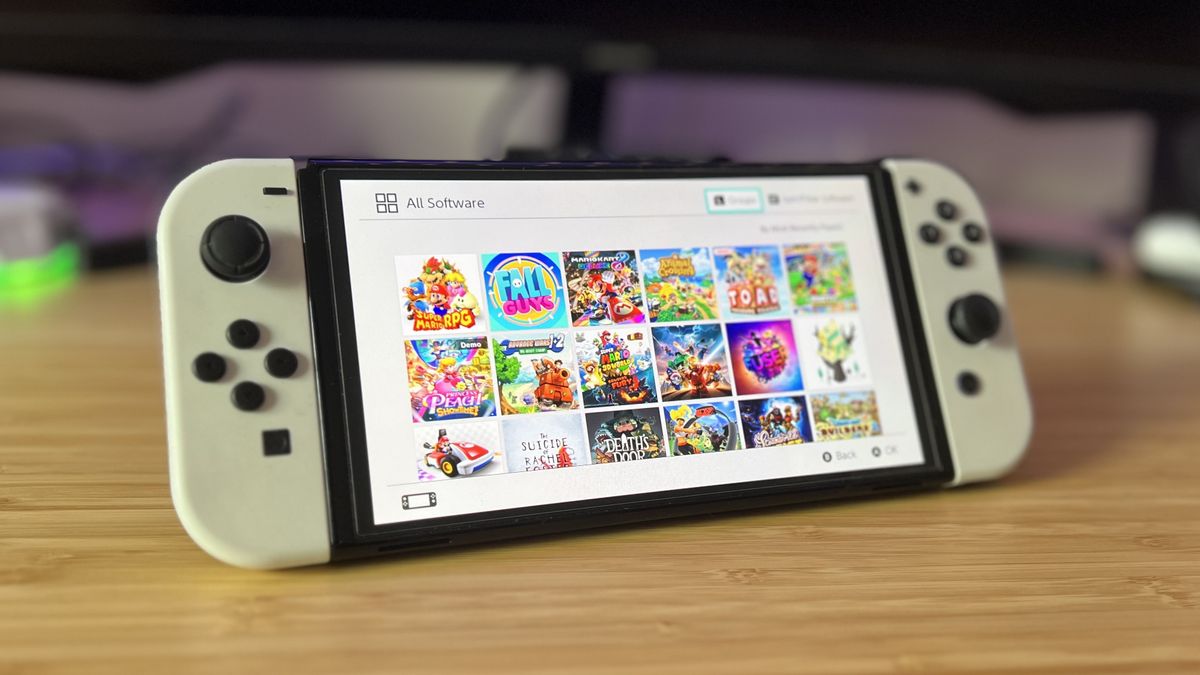 Nintendo Switch OLED showing downloaded games on a reviewer&#039;s desk