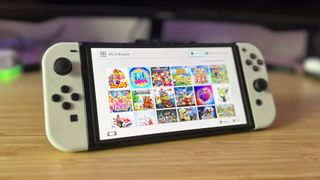 Nintendo Switch OLED showing downloaded games on a reviewer's desk