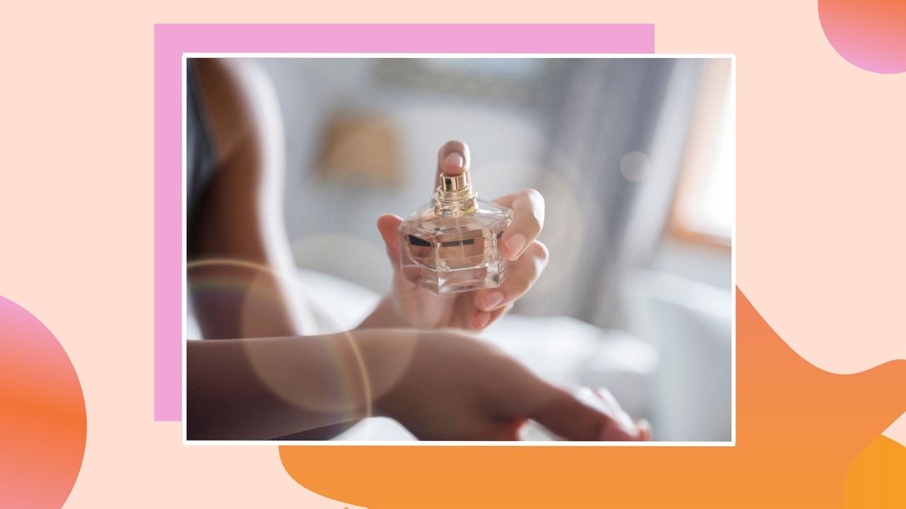 woman spraying perfume on wrist on a colorful pink and orange background