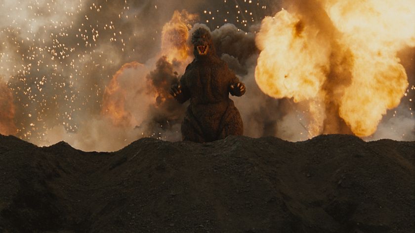 Godzilla emerging from an exploding volcano.