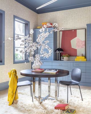 a home office with blue cabinets