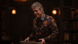 Hugh Grant as Mr. Reed holding a box in Heretic