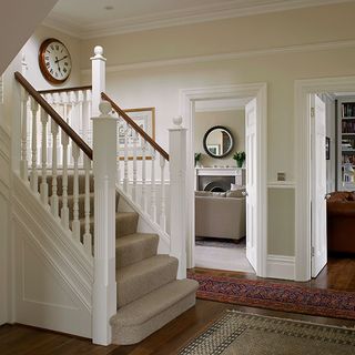 hallway of edwardian home with carpeted staircase