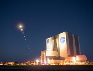 This composite made from 10 images shows the progression of the moon during a total lunar eclipse above the Vehicle Assembly Building, Nov. 8, 2022, at NASA’s Kennedy Space Center in Florida. Visible trailing the moon in this composite is Mars.