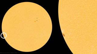 an image of the sun showing a dark sunspot near its edge