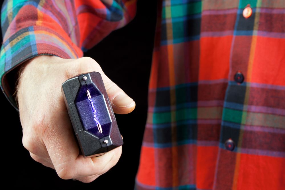 A man holds a stun gun.