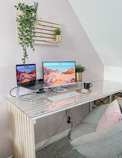 DIY slat desk with laptop, house plants and grey upholstered chair