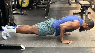 Lewis Paris demonstrates one position of the push-up exercise in a gym