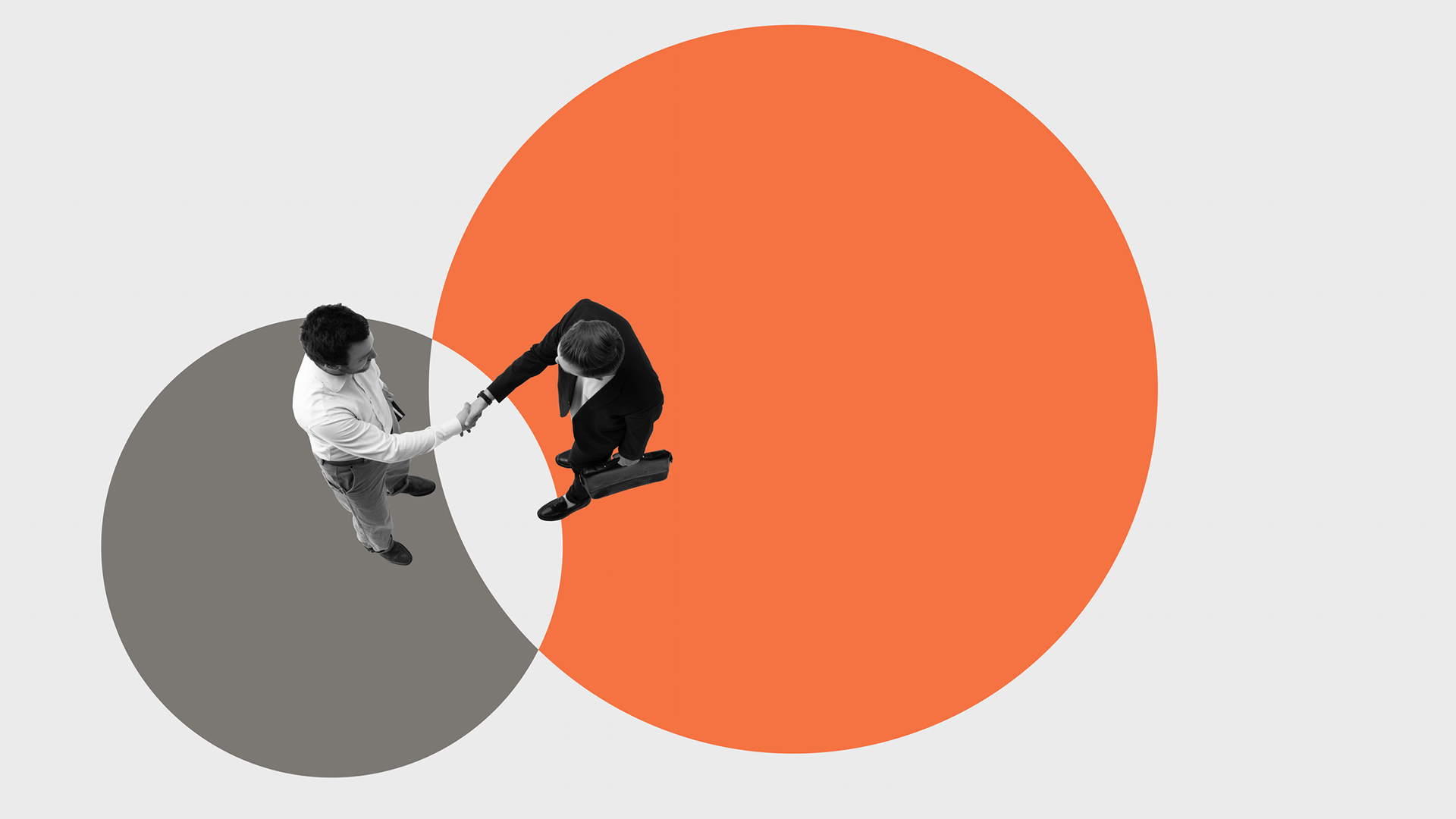 An image showing two grayscale businessmen shaking hands, overlaid on an illustration of a large orange circle intersecting with a gray circle against a white background.