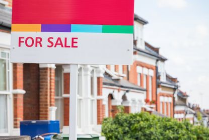 For Sale estate agent sign displayed outside a terraced house in Crouch End, London