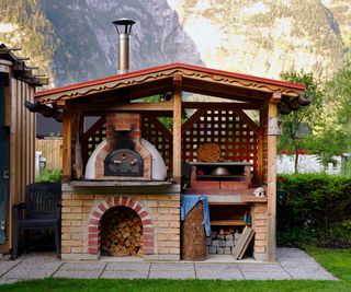 An example of a homemade brick pizza oven in a custom-built shelter