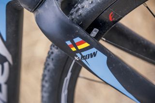 Decals on the carbon fork legs incorporate the Belgian flag