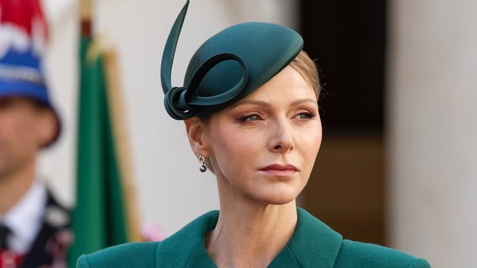 Princess Charlene wearing a green coat and hat