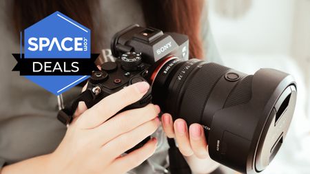 A large Sony camera being held. 