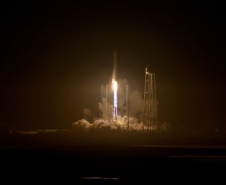 An upgraded Orbital ATK Antares rocket soars into the night sky over NASA's Wallops Flight Facility on Wallops Island, Virginia on Oct. 17, 2016.