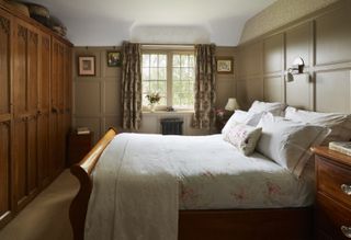 cottage with wooden panelling and wooden bed