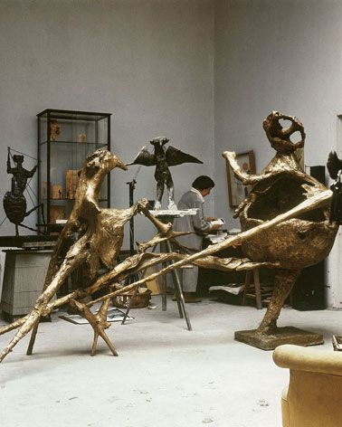 An exhibition space with eight bronze sculptures. 